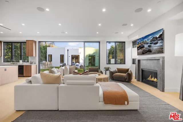 a living room with furniture fireplace and window