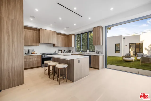 a kitchen with table chairs cabinets and appliances