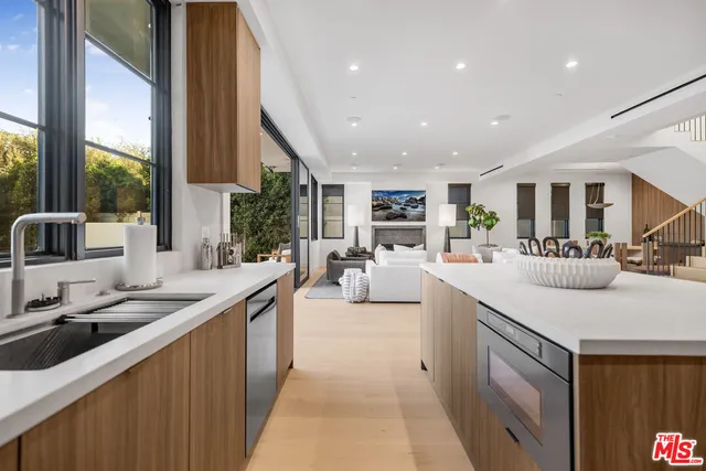 a kitchen with counter top space a sink and appliances