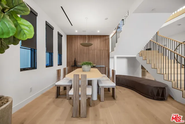 a view of a dining room with furniture and a potted plant
