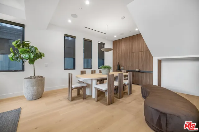 a view of a dining room with furniture and a potted plant