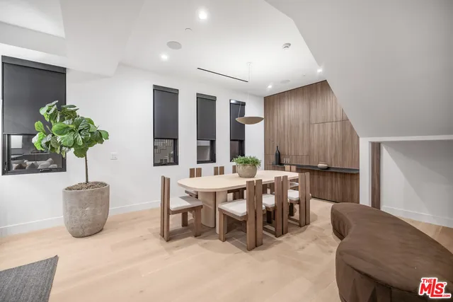 a living room with furniture a potted plant and a table