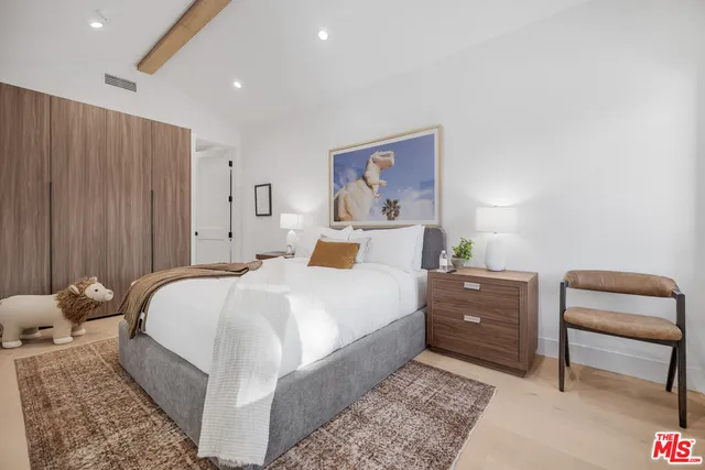 a bedroom with a bed and a chair