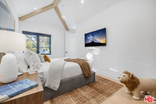 a bed room with a bed and a television