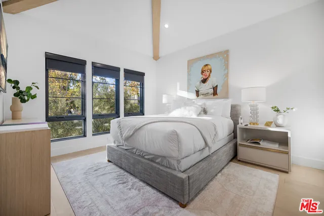 a bedroom with a large bed and a large window