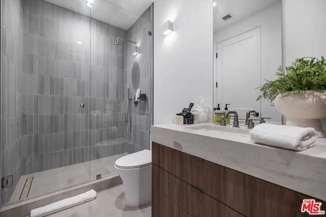 a bathroom with a bathtub shower sink and toilet