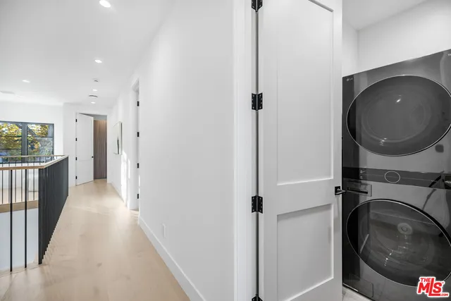 a view of a hallway with washer and dryer
