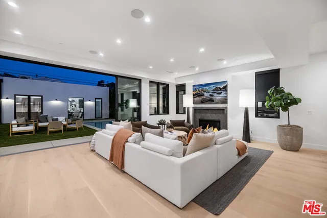 a view of living room with furniture and a fireplace