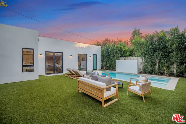 a view of a backyard with sitting area