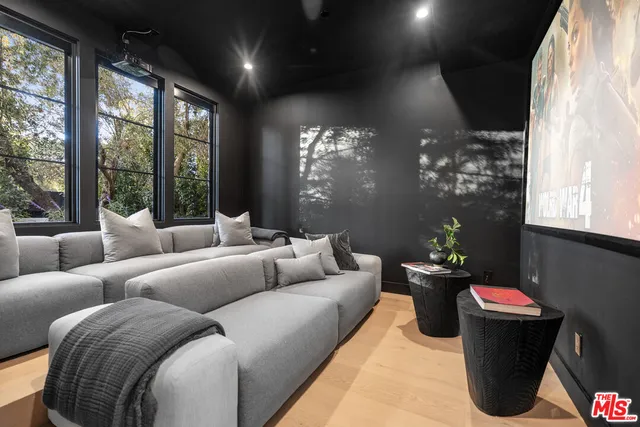 a living room with furniture chandelier and a large window