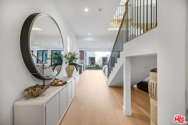 a view of a livingroom with furniture and staircase