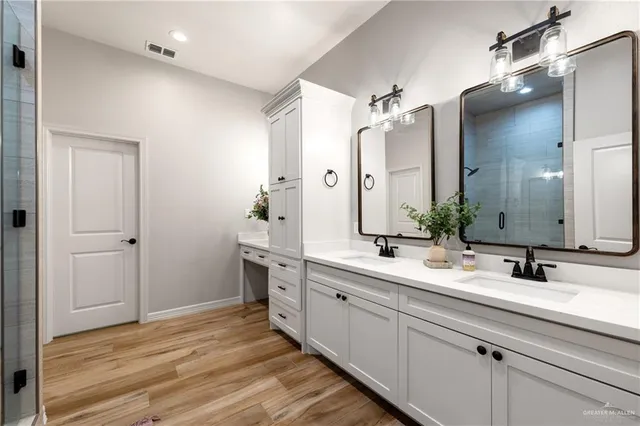 a bathroom with a double vanity sink mirror and double