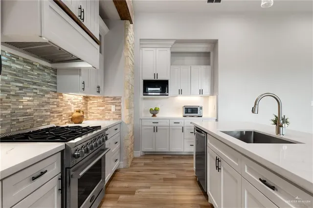 a kitchen with cabinets and appliances