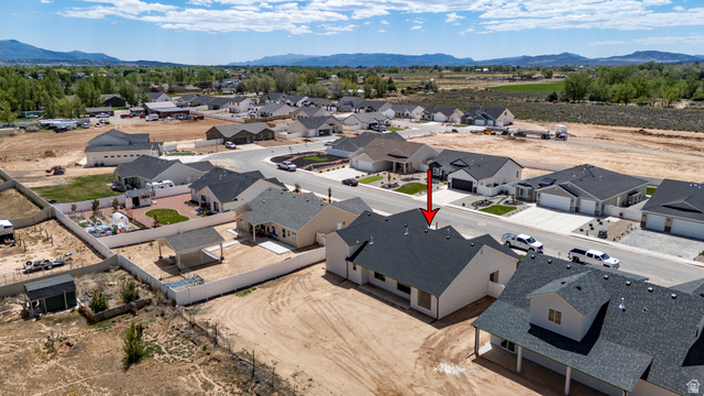 4978 North 75 East Enoch, UT 84721 - Photo 54 of 60 Aerial perspective of a residential neighborhood featuring single-story homes with dark shingle roofing