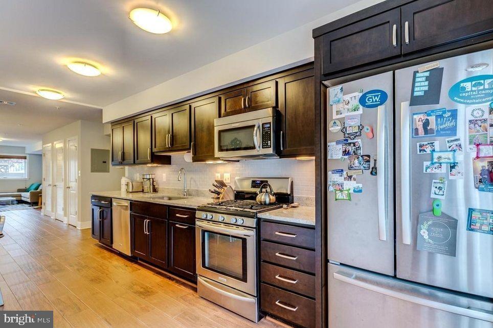 3465 14th Street Northwest, Unit A Washington, DC 20010 - Photo 15 of 28 a kitchen with stainless steel appliances granite countertop a refrigerator and a stove top oven