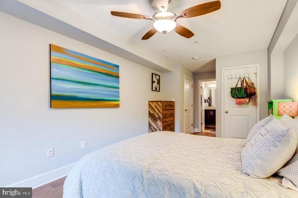 3465 14th Street Northwest, Unit A Washington, DC 20010 - Photo 20 of 28 a bedroom with a bed and a chandelier