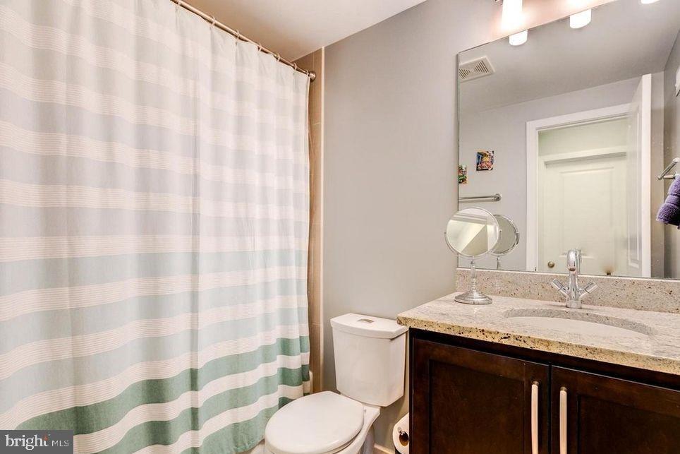 3465 14th Street Northwest, Unit A Washington, DC 20010 - Photo 22 of 28 a bathroom with a granite countertop sink and a mirror