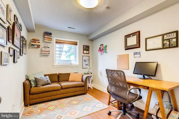 a view of a livingroom with workspace and a couch