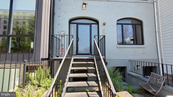 a view of staircase with white walls and a floor to ceiling window
