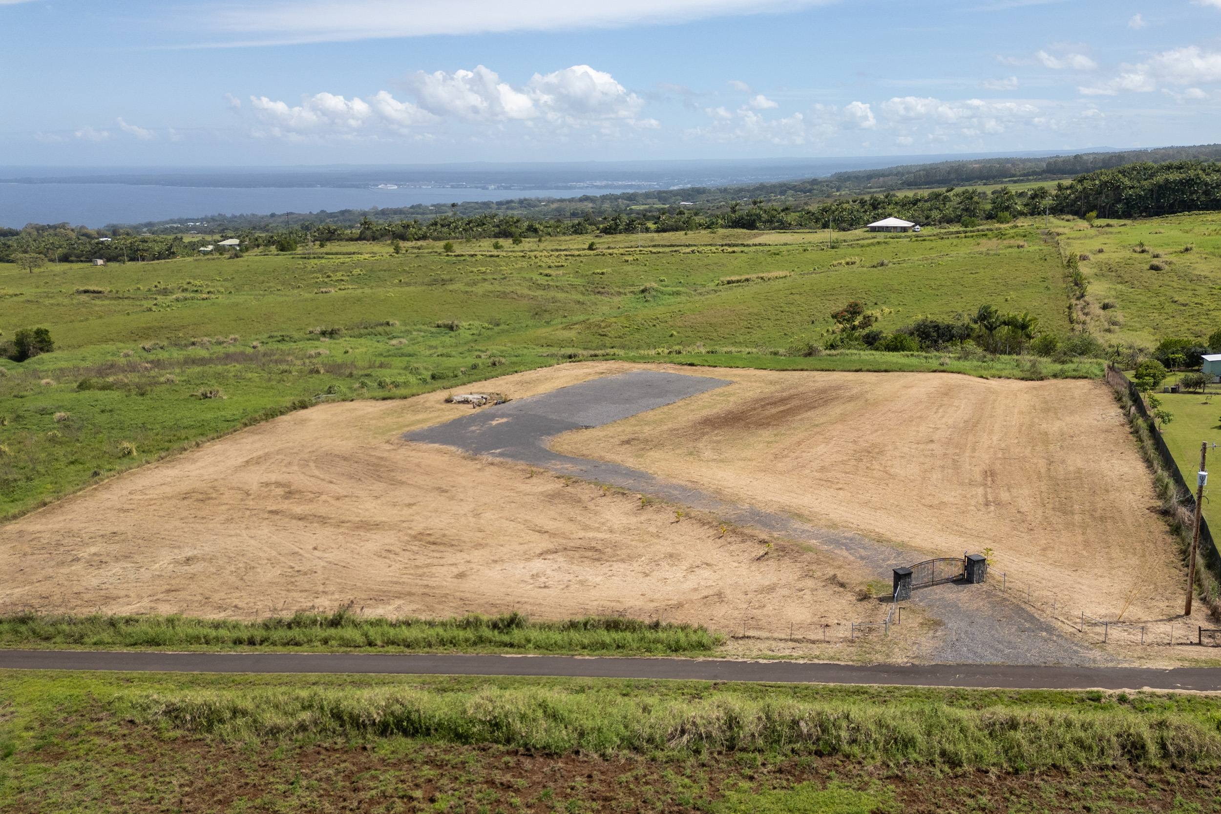 27-990 Lot 24-b-5 Onohi Loop Papaikou, HI 96781 - Photo 11 of 16 a view of a lake with a city