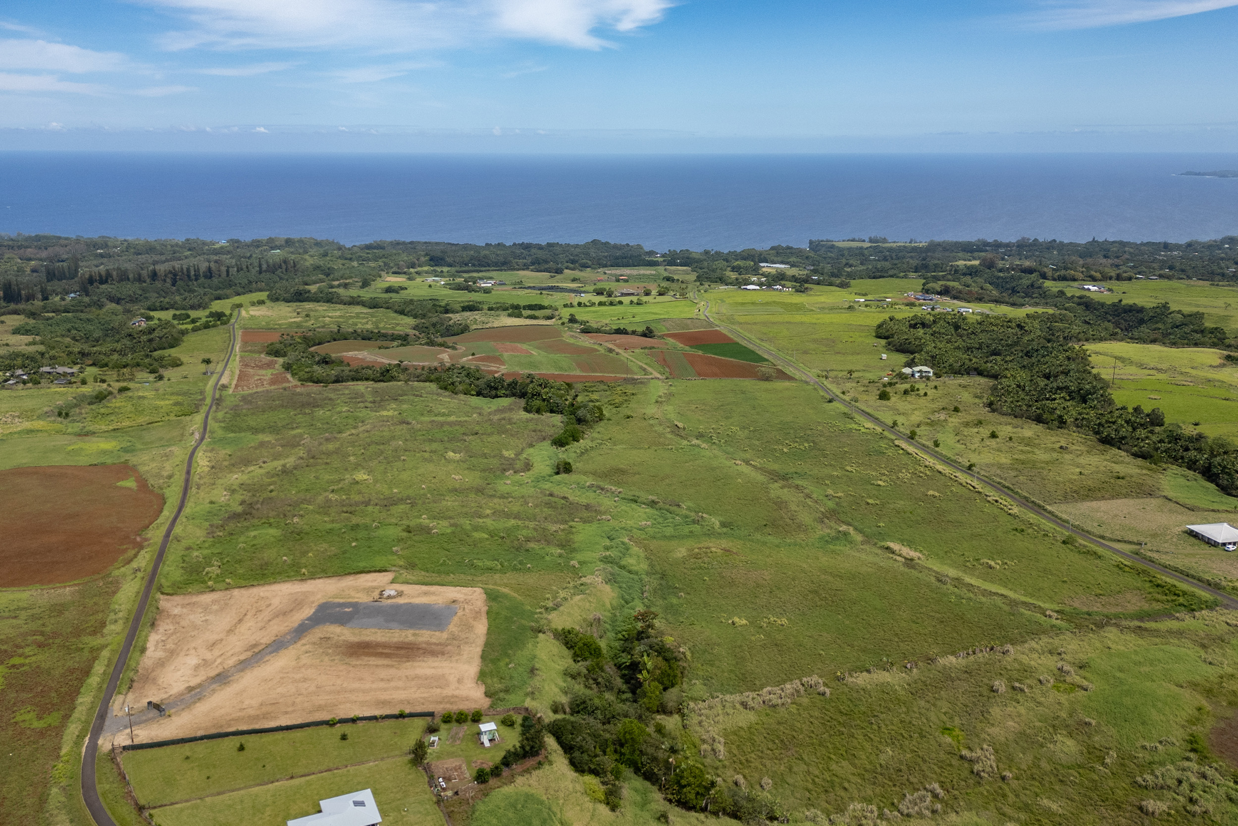 27-990 Lot 24-b-5 Onohi Loop Papaikou, HI 96781 - Photo 8 of 16 a view of a lake with a city