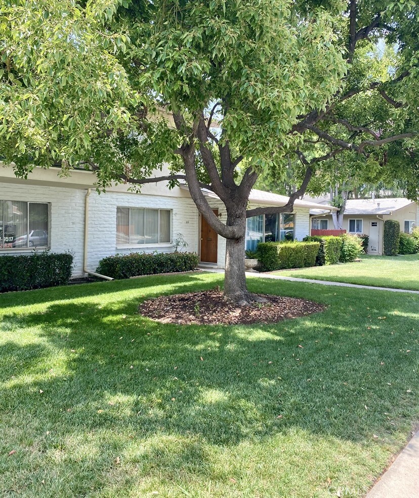 a front view of a house with a garden