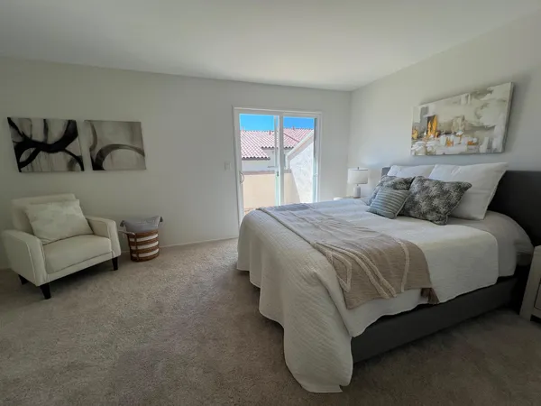 a spacious bedroom with a bed and a couch