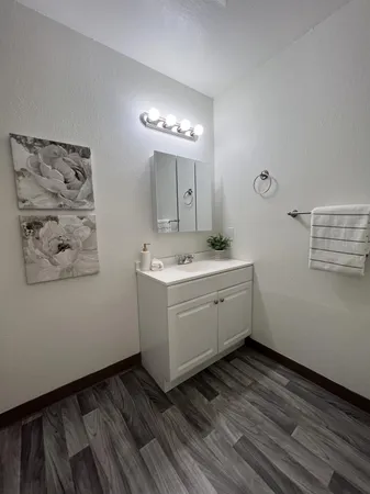 a room with a white cabinets and wooden floor