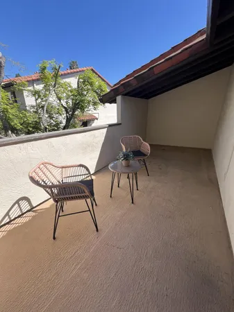 a view of patio with table and chairs and potted plants