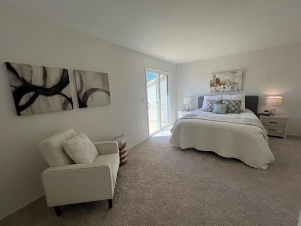 a bedroom with bed couch and window