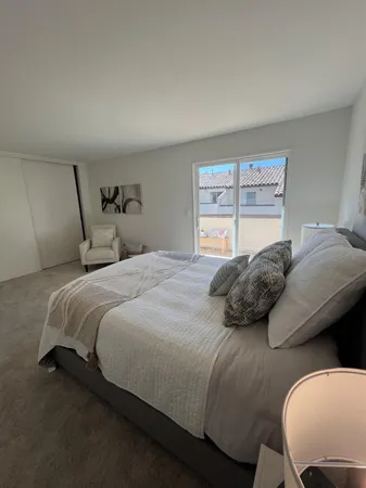 a bedroom with a bed and window
