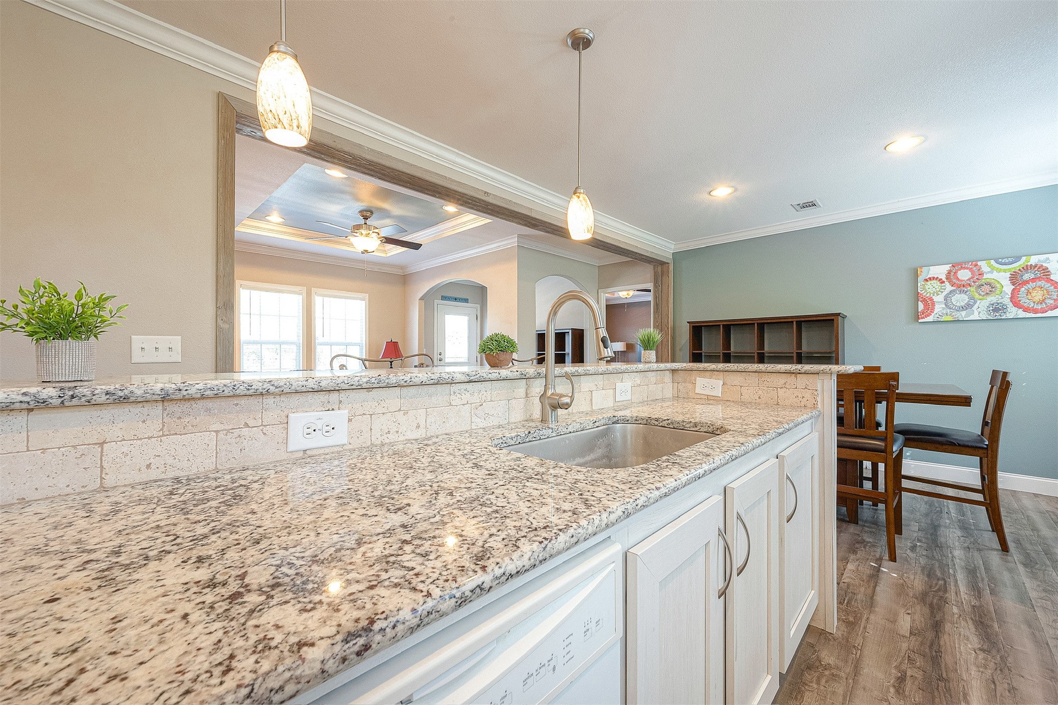 20547 South Post Oak Boulevard, Unit B Fresno, TX 77545 - Photo 23 of 46 a view of a kitchen with kitchen island a sink a counter top space and living room view