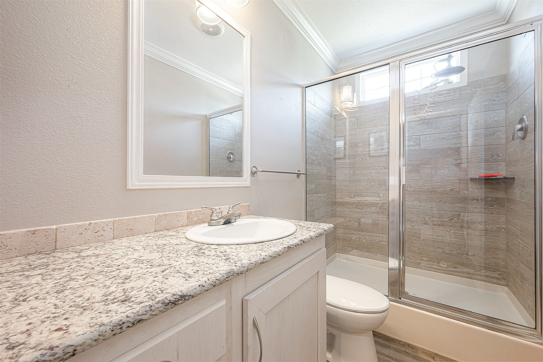 20547 South Post Oak Boulevard, Unit B Fresno, TX 77545 - Photo 35 of 46 a bathroom with a granite countertop sink a toilet and shower