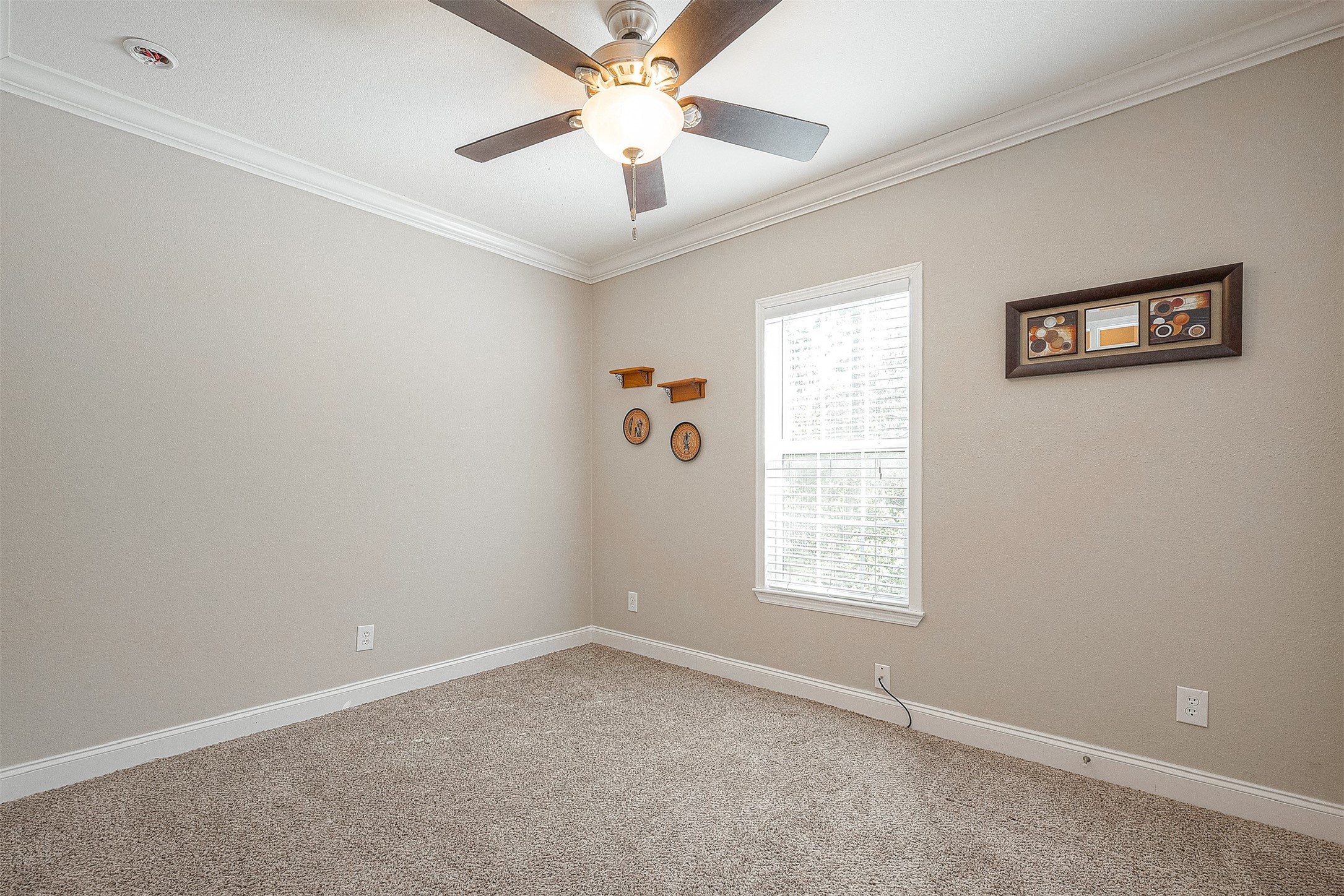 20547 South Post Oak Boulevard, Unit B Fresno, TX 77545 - Photo 43 of 46 an empty room with windows and fan