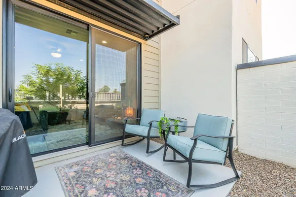a balcony with furniture and a potted plant