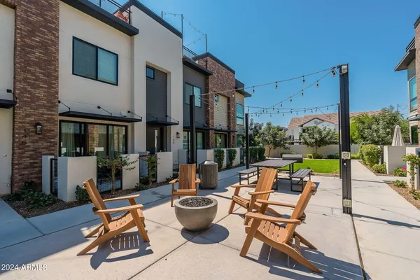 a view of a patio with a dining table and chairs with wooden floor