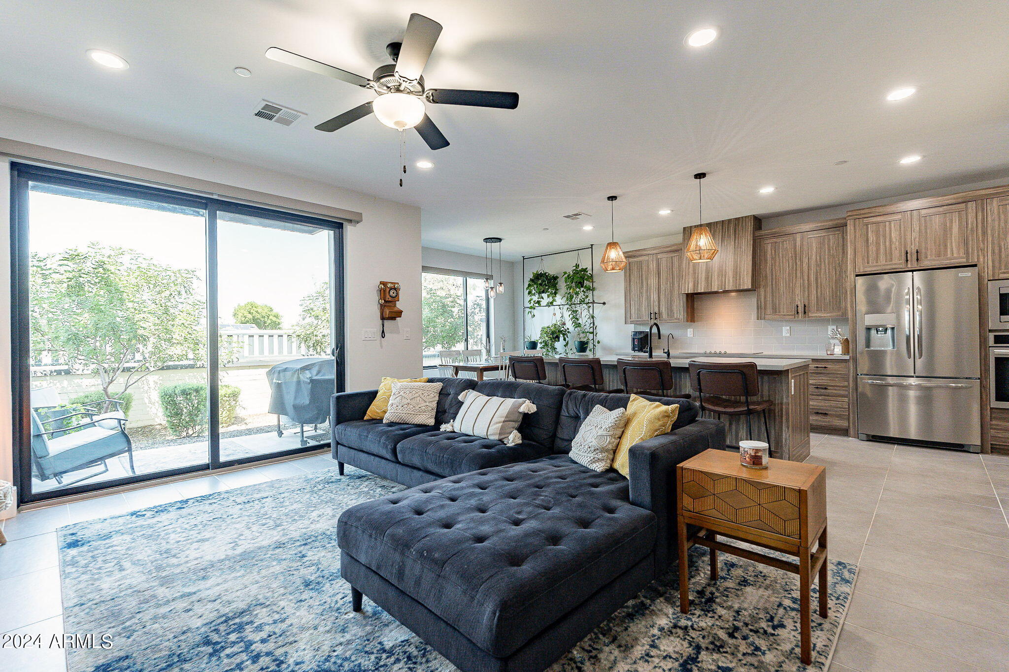 142 East Hearne Way Gilbert, AZ 85234 - Photo 2 of 44 a living room with furniture and a large window with kitchen view