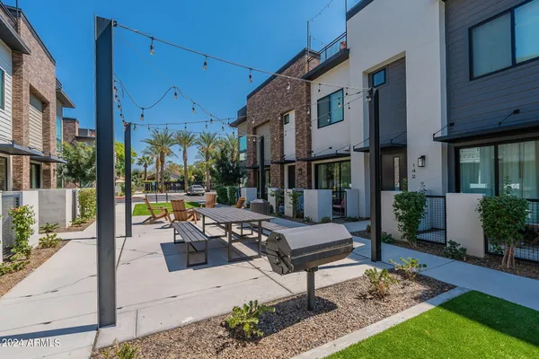 a view of a patio with couches table and chairs and potted plants