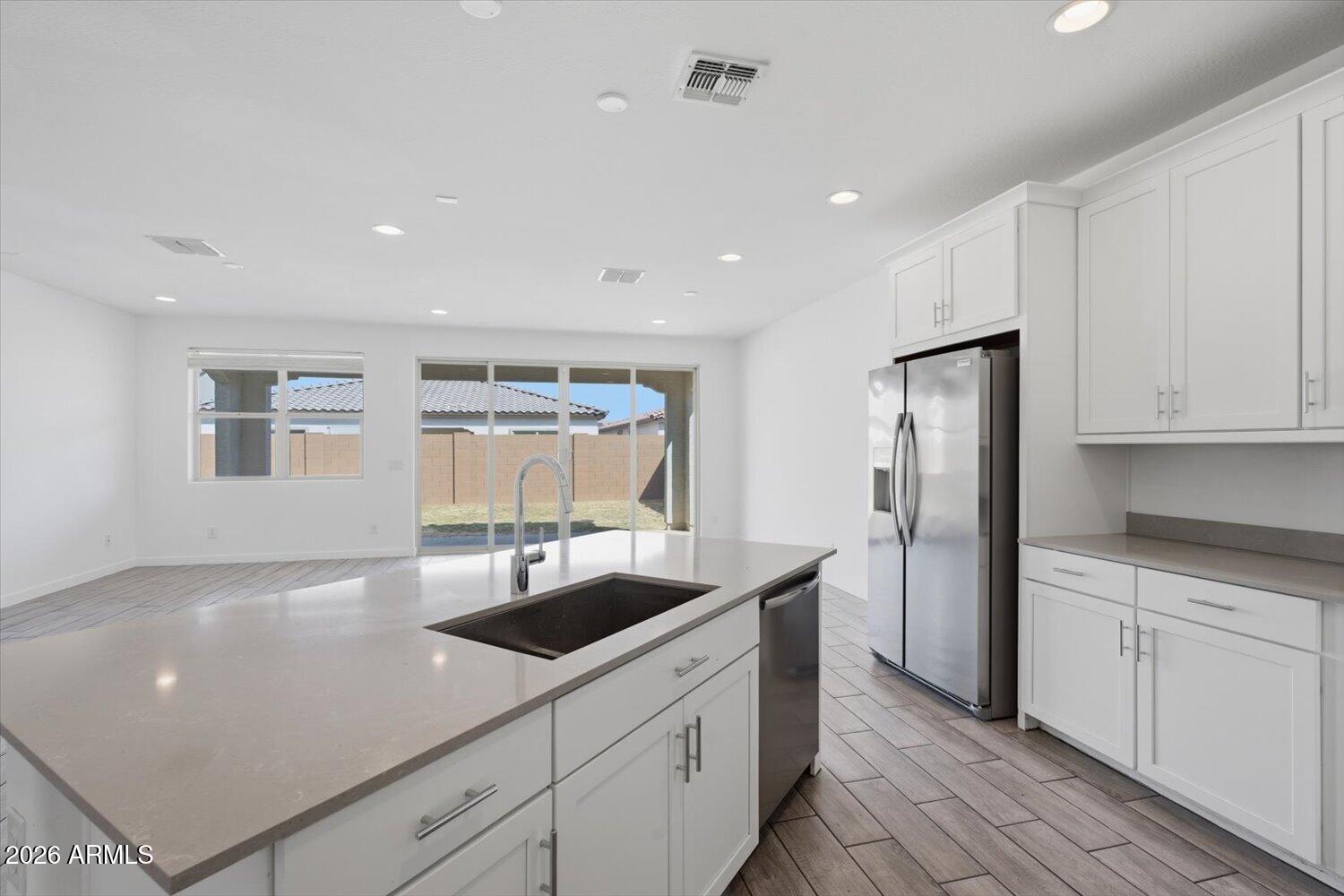 2542 West Pecan Road Phoenix, AZ 85041 - Photo 10 of 30 a kitchen with stainless steel appliances granite countertop a sink and a refrigerator