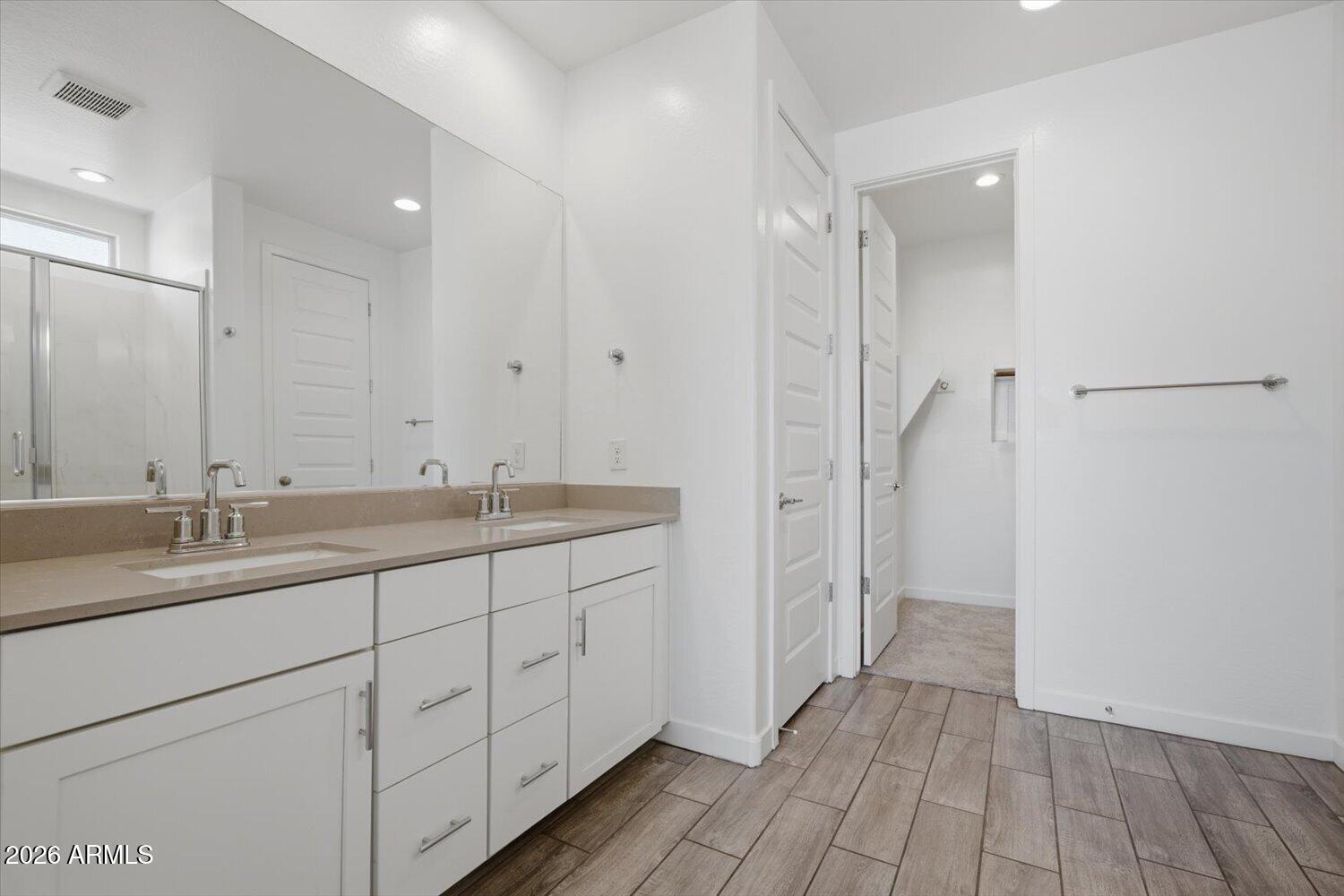 2542 West Pecan Road Phoenix, AZ 85041 - Photo 17 of 30 a bathroom with a double vanity sink and mirror