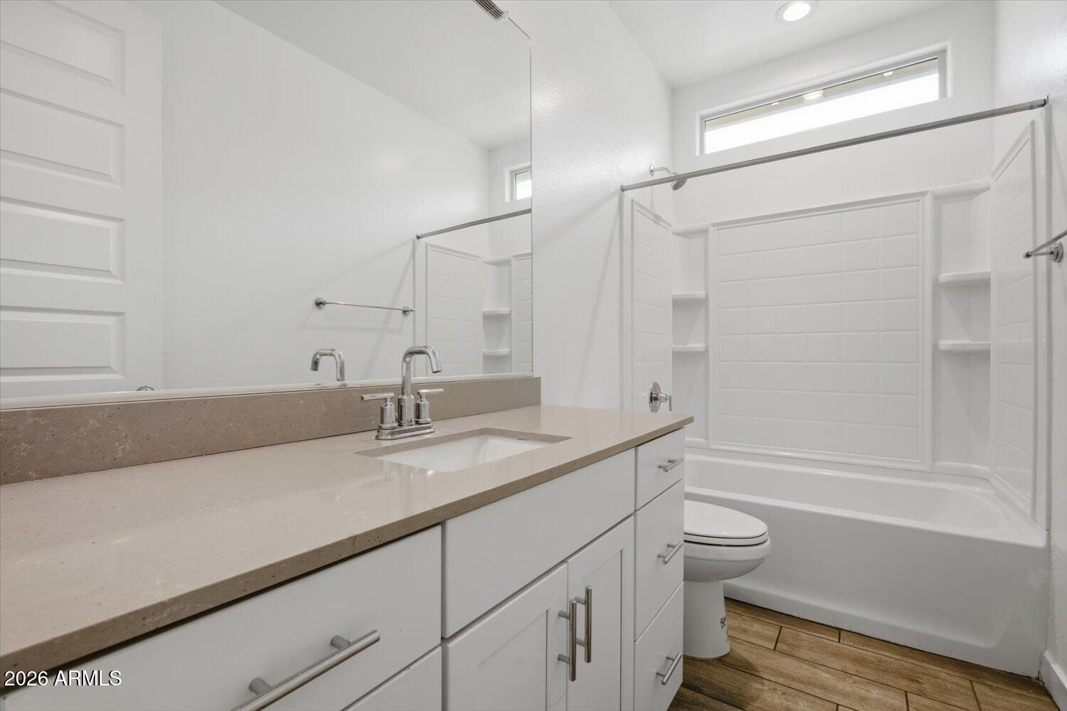 2542 West Pecan Road Phoenix, AZ 85041 - Photo 21 of 30 a bathroom with a granite countertop sink a toilet and bathtub