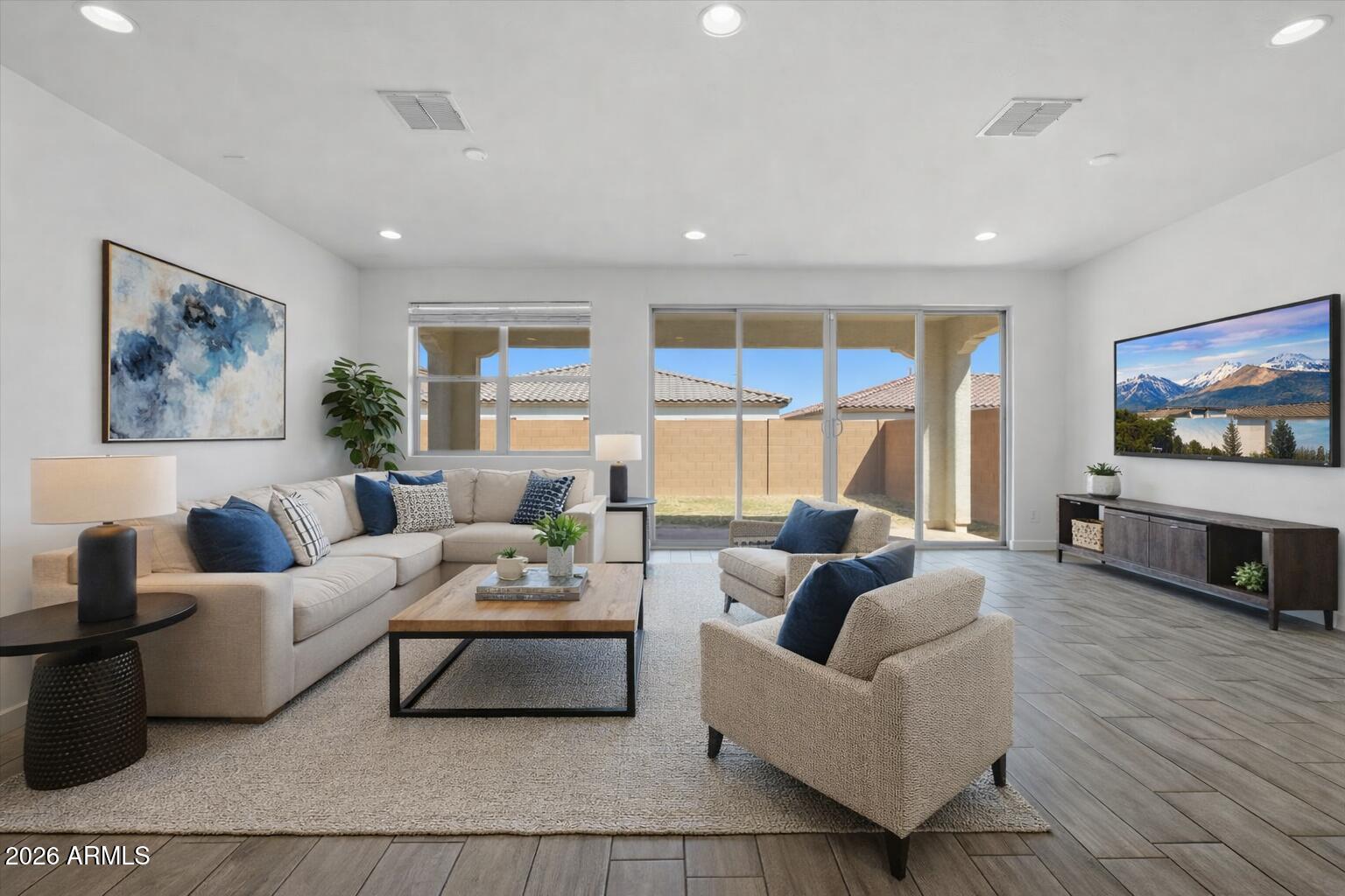 2542 West Pecan Road Phoenix, AZ 85041 - Photo 2 of 30 a living room with furniture and a flat screen tv