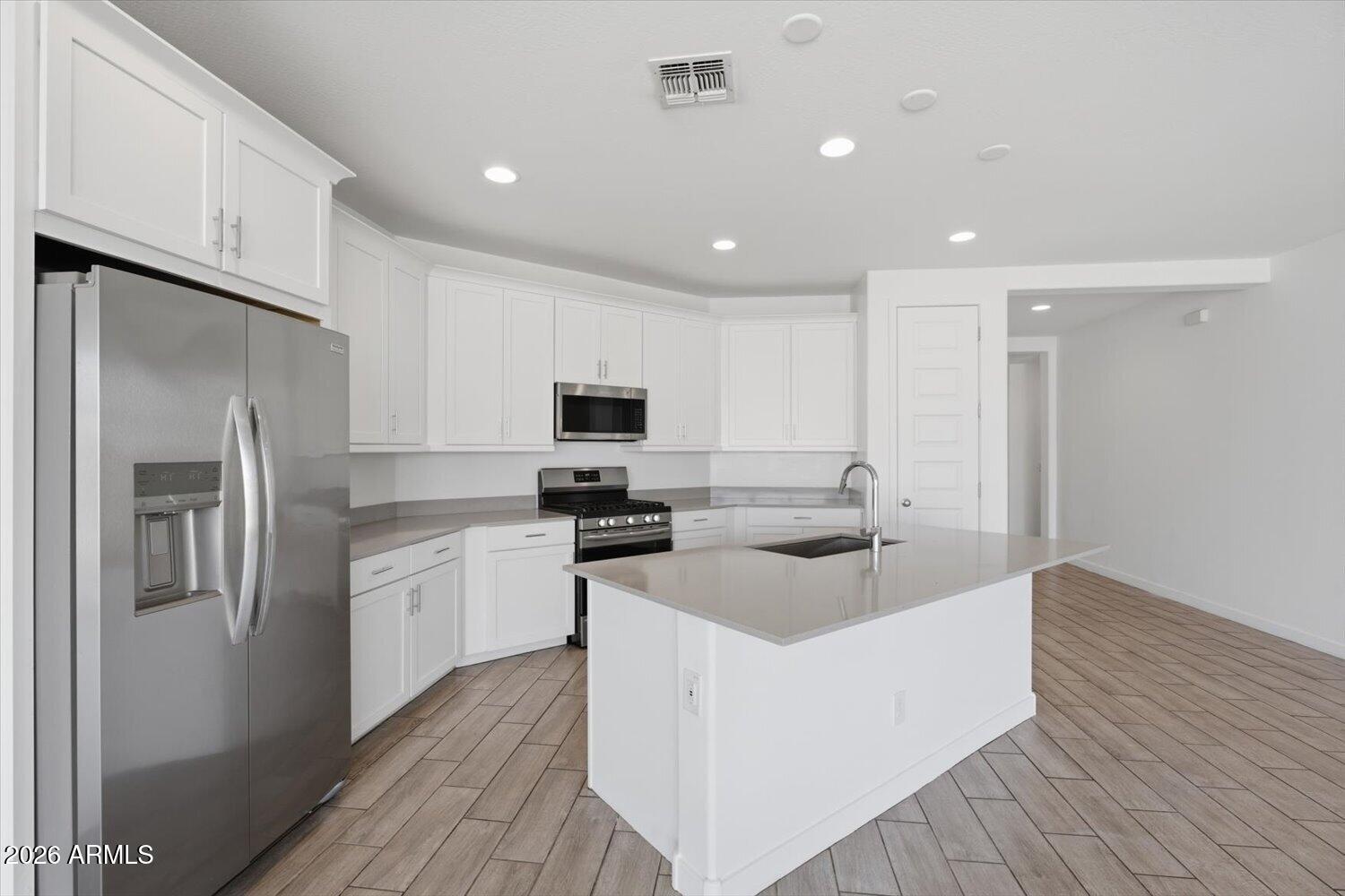2542 West Pecan Road Phoenix, AZ 85041 - Photo 7 of 30 a kitchen with stainless steel appliances granite countertop a sink stove and refrigerator