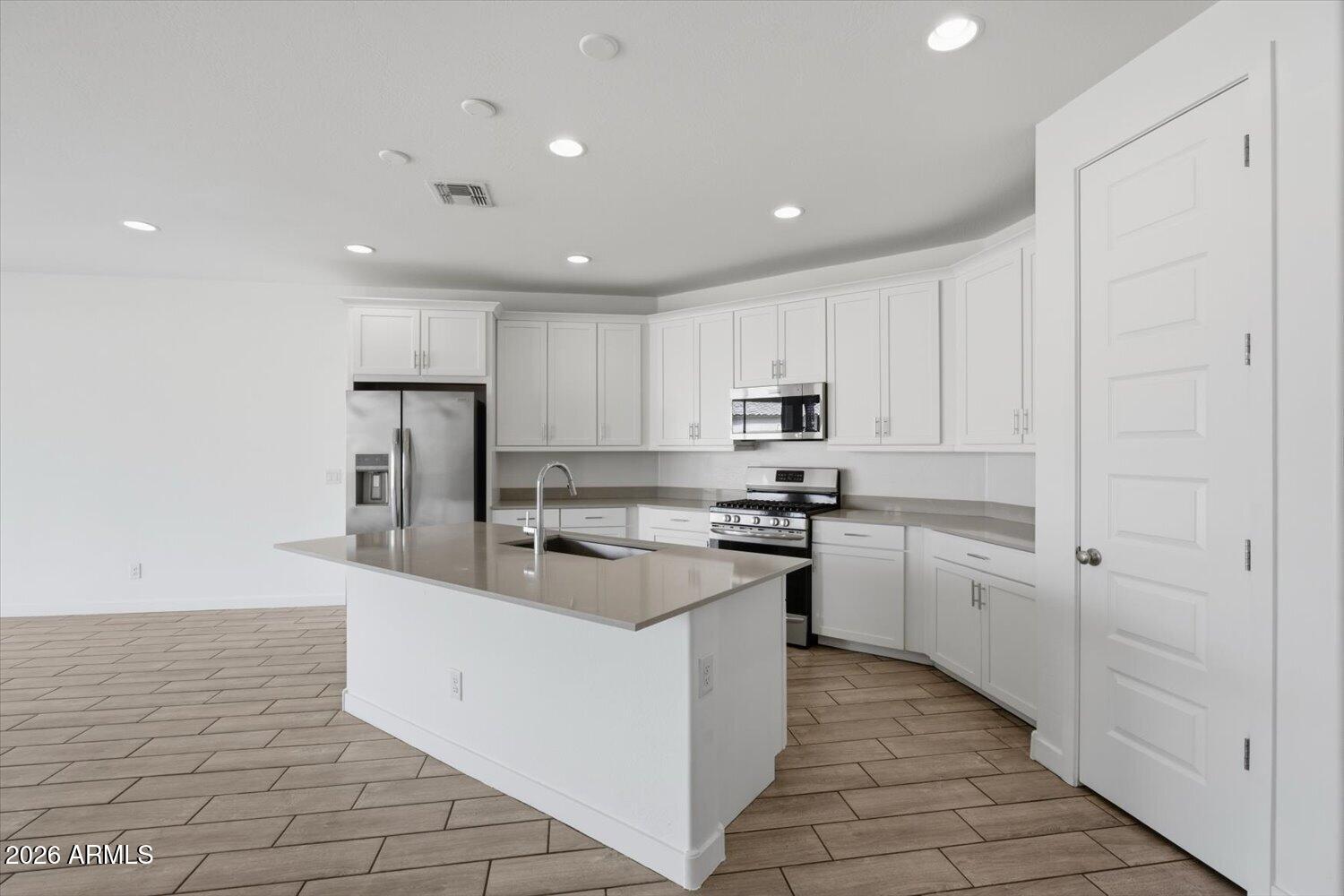 2542 West Pecan Road Phoenix, AZ 85041 - Photo 9 of 30 a kitchen with refrigerator and cabinets