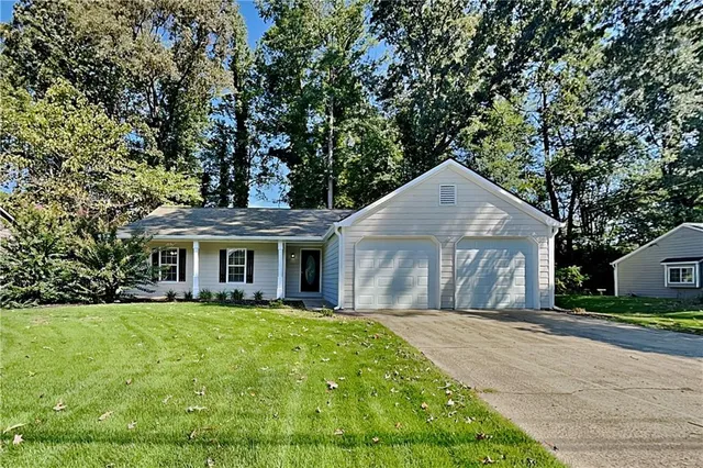 a front view of house with yard and green space