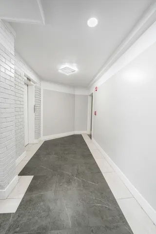 an empty room with a empty space and windows