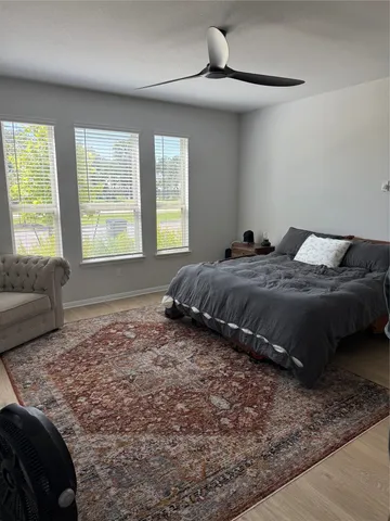 a bedroom with a bed and glass windows