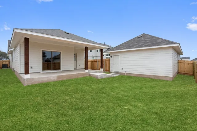 a view of a house with a backyard
