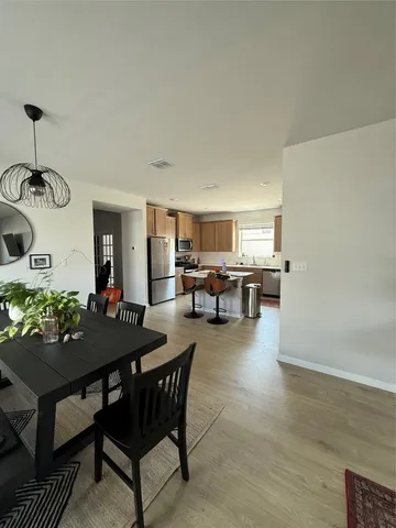 a view of a dining room with furniture and chandelier