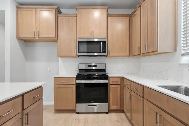 a kitchen with granite countertop a stove and a sink
